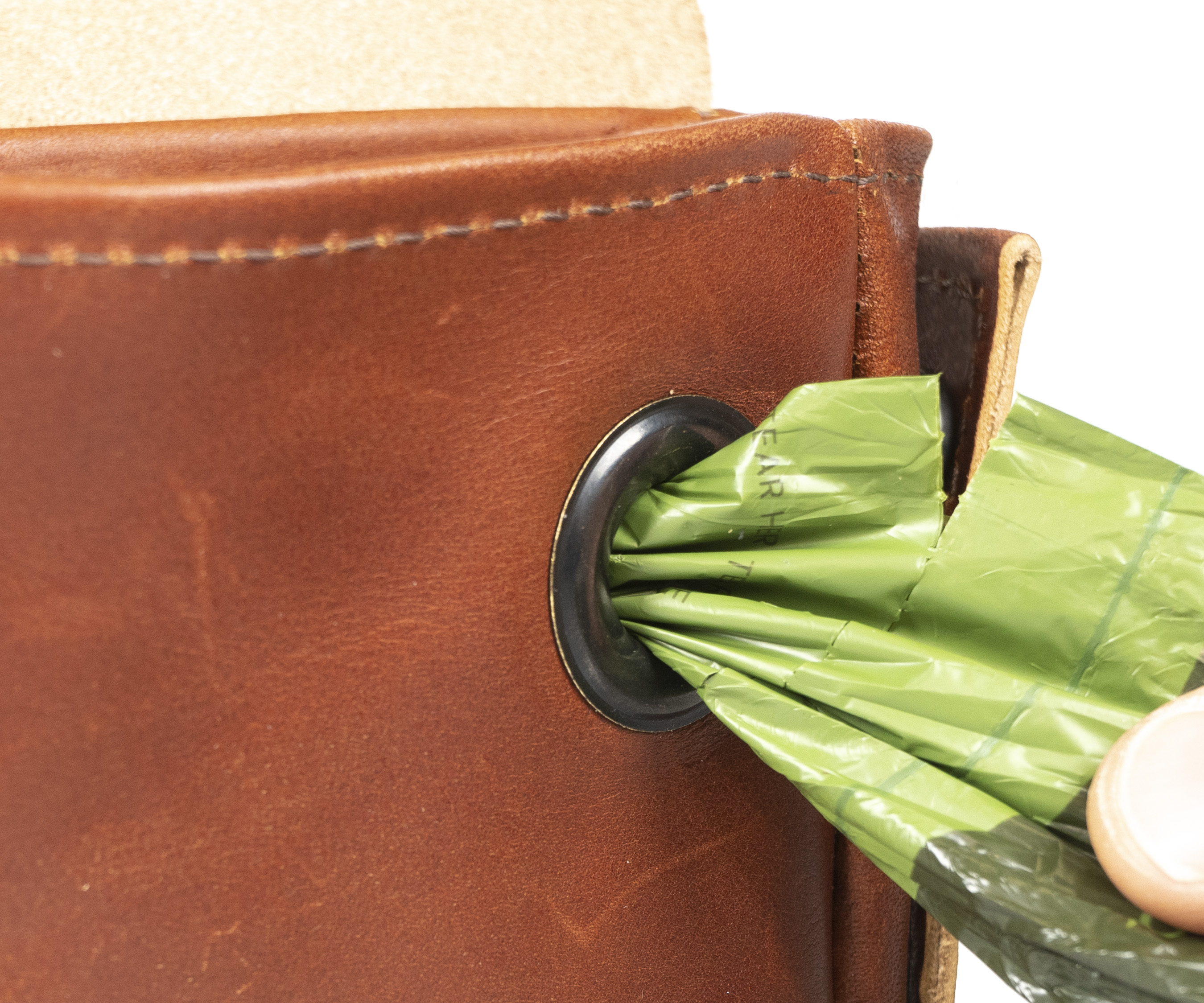 Poop-bag dispenser hides discreetly behind a full-grain leather flap
