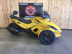 The side view of a yellow 2013 Can-Am Spyder available at Twisted Cycles.