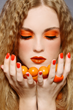 Consumer glowing in Rising Orange cosmetics