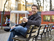 Paul Louis Metzger Bio Photo for Wipf and Stock book publishers drinking coffee on bench in portland oregon park with streetcar and sunset