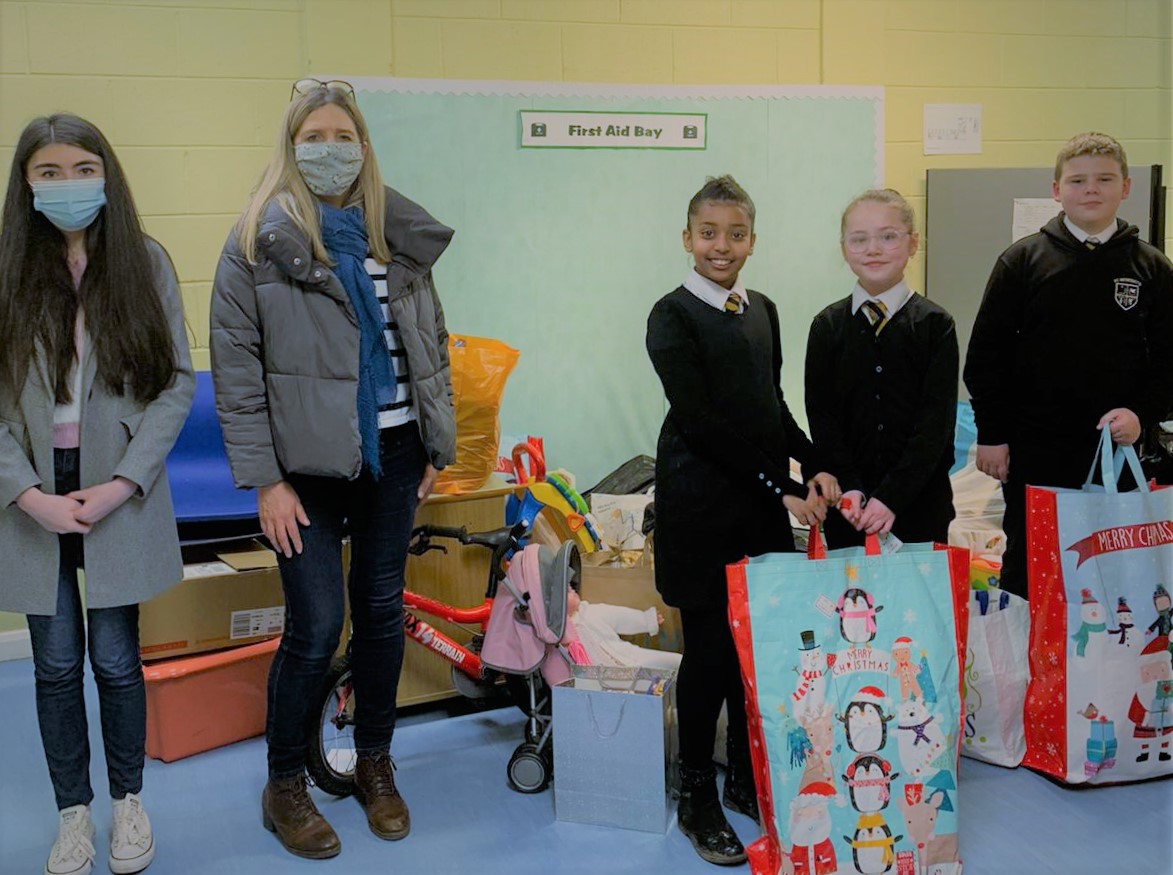 School children receive gifts from Stars staff following company-wide Christmas appeal.jpg