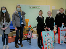 School children receive gifts from Stars staff following company-wide Christmas appeal