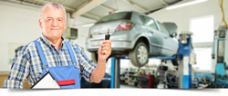 Mechanic holding car keys of a car being worked on in the shop