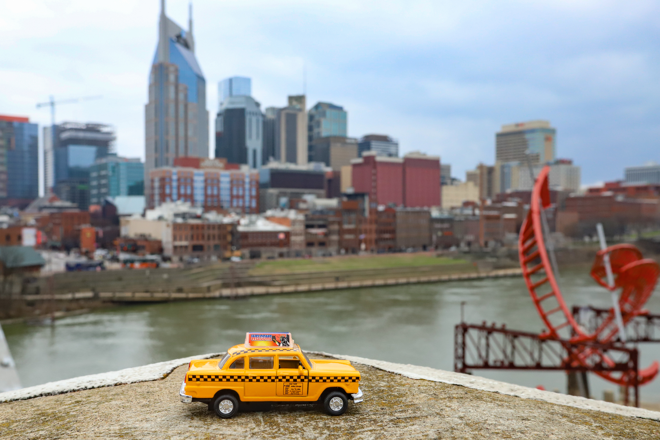 The Nashville, Tennessee skyline behind a yellow taxi. The coronavirus has taken a toll on transportation companies, especially in cities known for tourism, like Nashville.