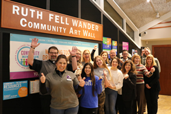 CTAD directors and volunteers proudly show off the educational wall displayed at First Bank of Highland Park.