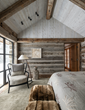 The master bedroom of this JLF Architects house features reclaimed logs from a historic Montana cabin paired with a contemporary glass and steel window for embracing views (PC: Audrey Hall).