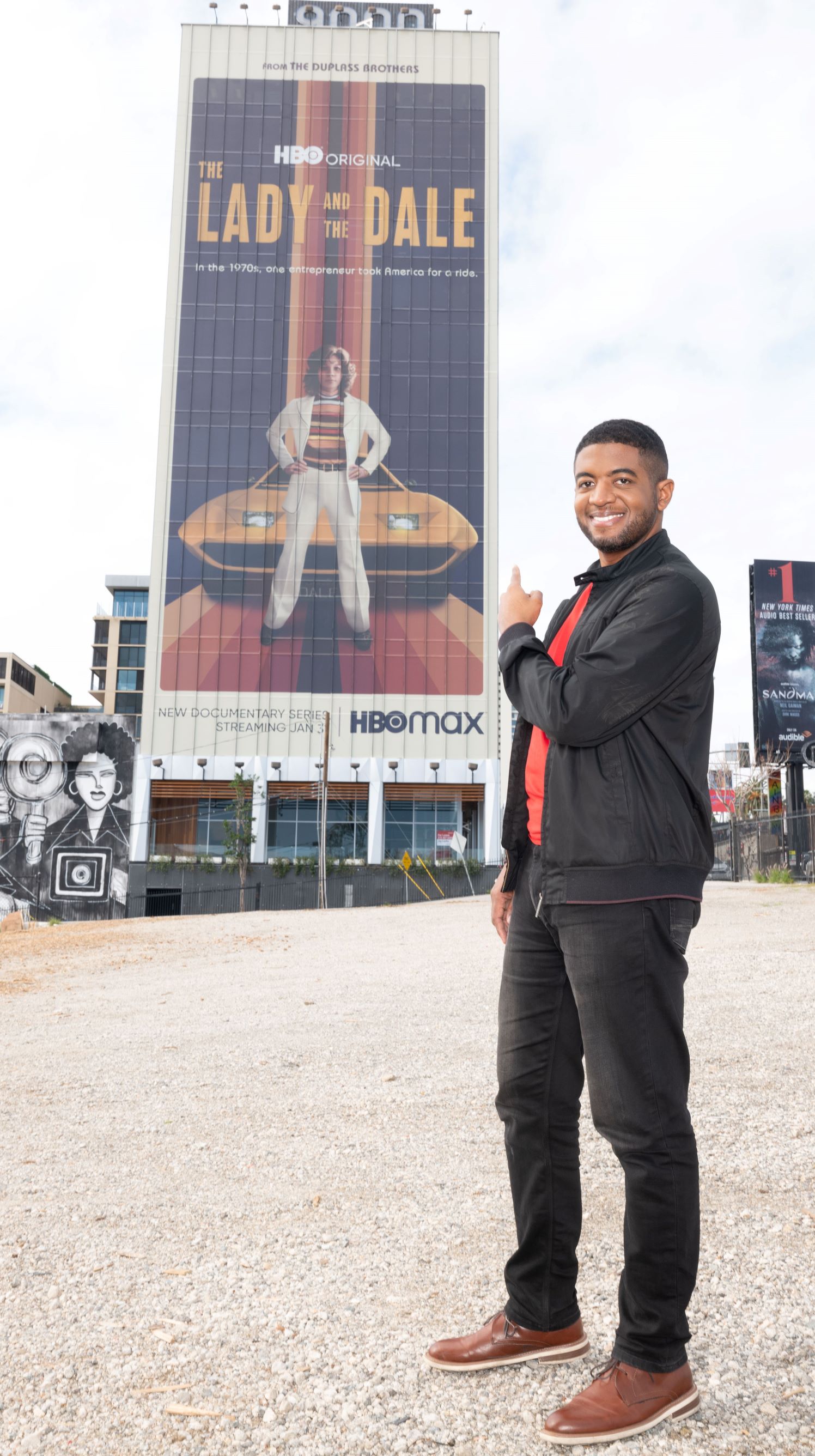 Film and Television Producer Andre Gaines of Cinemation Studios Poses in front of The Lady and The Dale Billboard on Sunset Strip