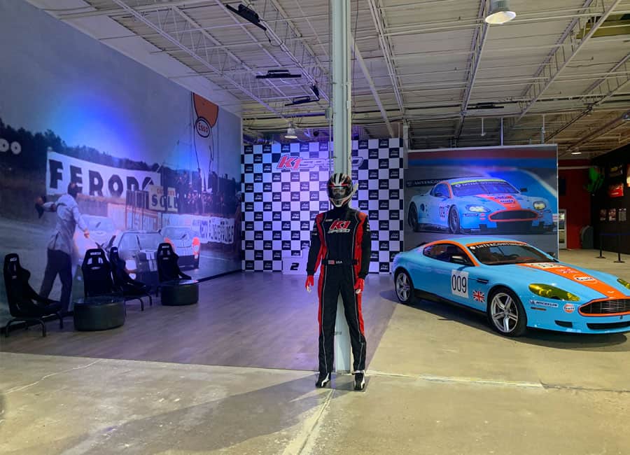 The lobby at K1 Speed Oxford featuring an Aston Martin and podium
