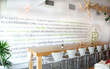 PrestoTex is installed on a full wall featuring a brand manifesto in green, black and gray along with the company logo