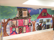 The artwork of children is featured on the walls of a playroom using PrestoTex