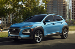 The front and side view of a blue 2021 Hyundai Kona