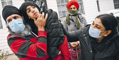 Sukhdev Singh, holding disabled daughter Ashmeet, 8, and wife Rajwinder, right.