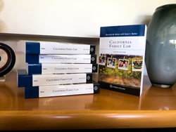 A stack of books with the spines face forward with the title of "California Family Law," one book to the right of the stack faces forward where you can see the cover of California Family Law. The cover of the textbook includes diverse families.