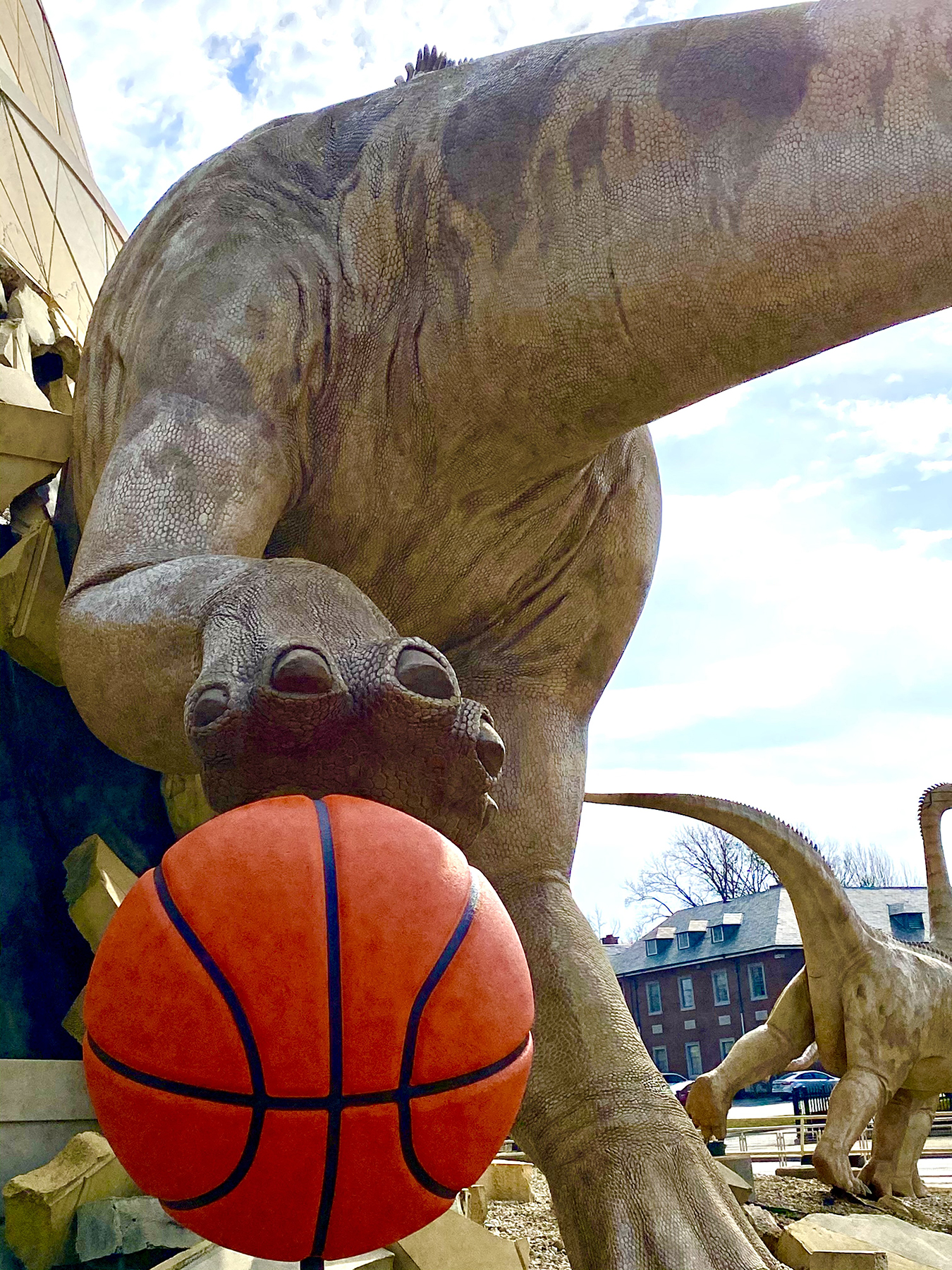 Basketball is so huge in Indianapolis that the dinosaurs are breaking out of buildings to hoop it up!
