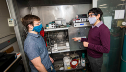 Worcester Polytechnic Institute professor Andrew Teixeira (right) confers with PhD student Cameron Armstrong, who custom built an ultrafast micro catalytic reactor to produce ammonia.