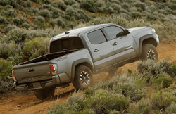 2021 Toyota Tacoma driving up a hill
