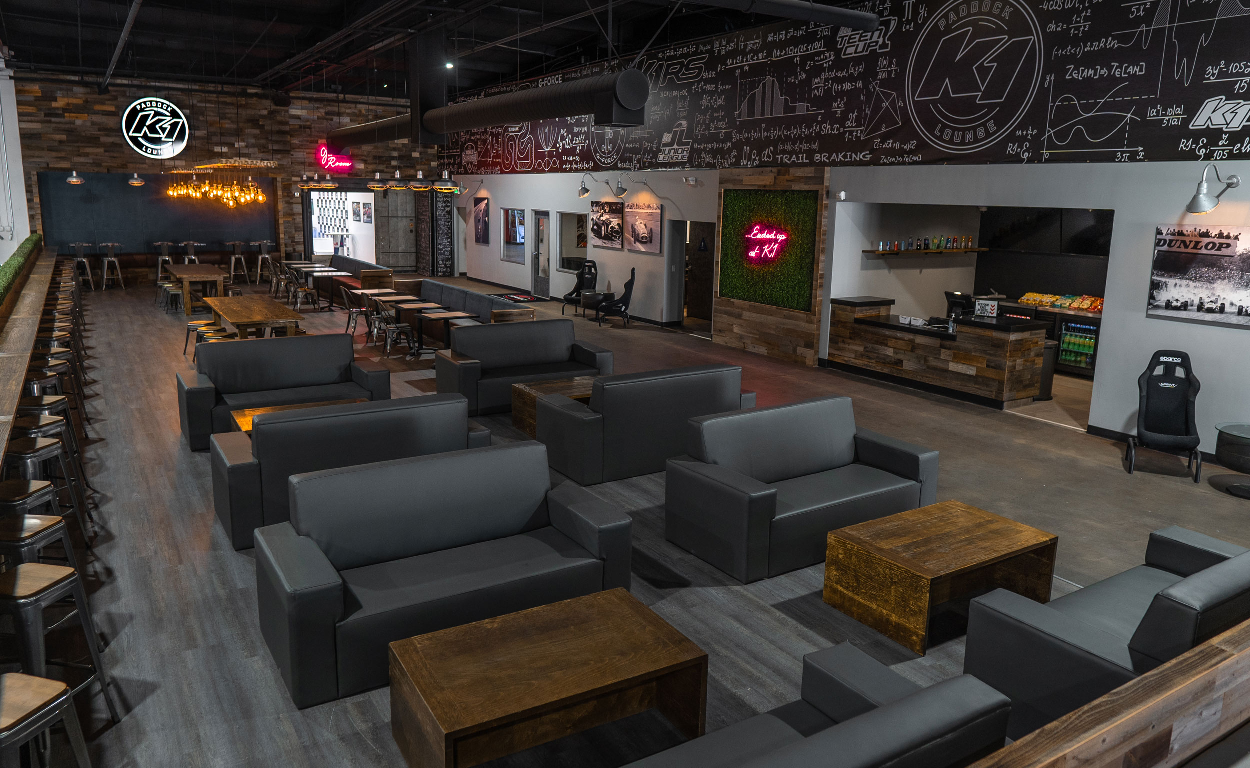 The upscale Paddock Lounge and Lobby inside K1 Speed Burbank offers plenty of seating trackside in a sophisticated environment that features leather couches.