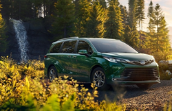 2021 Toyota Sienna parked in front of a waterfall