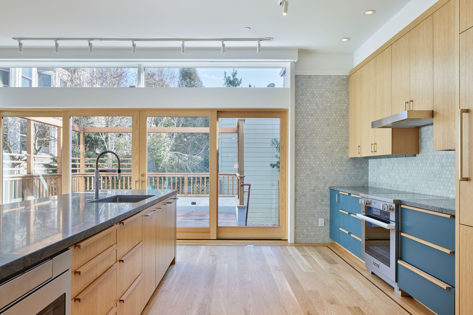 The kitchen was opened up with a new south facing sliding door to let in views and light and connect to the outside.