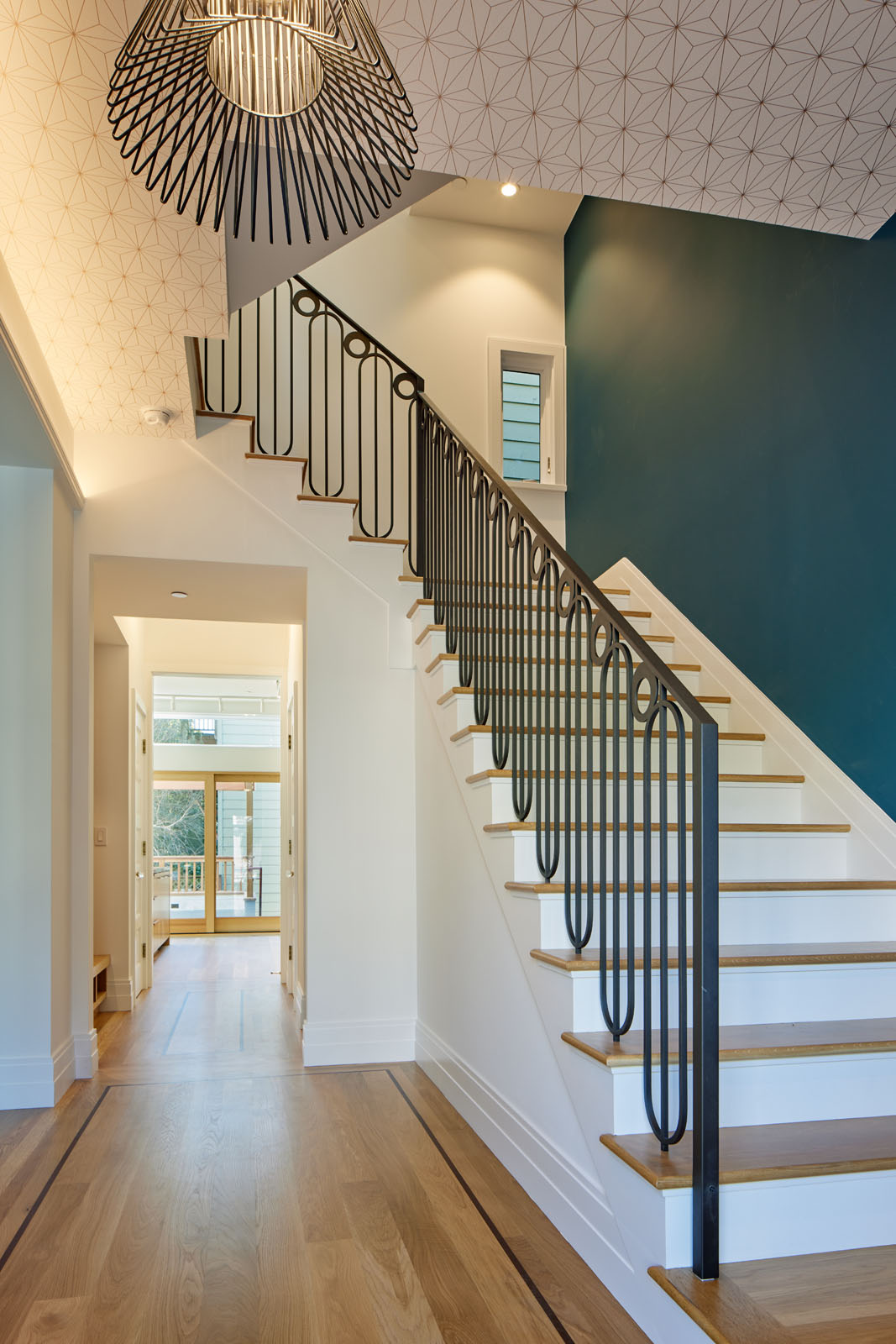 We designed a new custom metal decorative railing for the stairs then stacked a new 3 flight stair to reach the legalized attic space.