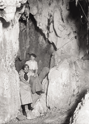 Historic circa 1900 black-and-white photo of two young women in Gibson-girl outfits inside Glenwood Caverns, then known as Fairy Caves.