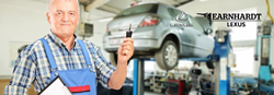 Mechanic Holding a Car Key in a Garage with Earnhardt Lexus Logo
