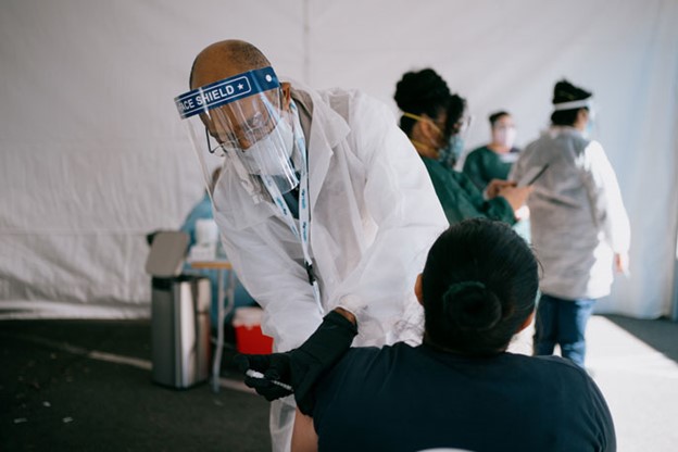 UC President Michael V. Drake, M.D., administering COVID-19 vaccinations this spring at a community pop-up immunization hub in San Francisco’s Mission District. Credit: University of California