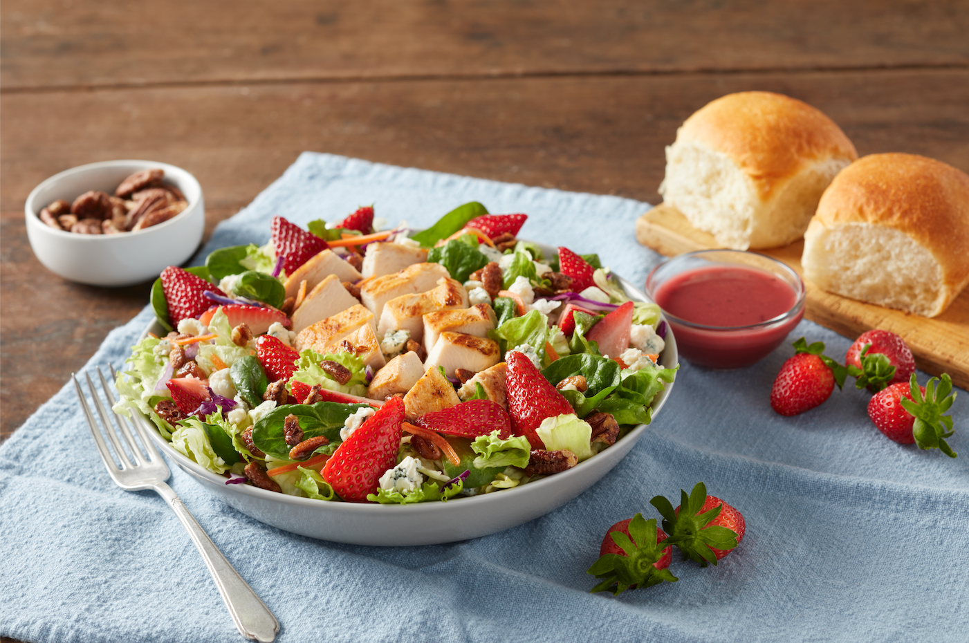 The Summer Berry Salad is a bed of fresh greens topped with chicken grilled to perfection, vine-ripened strawberries, pecans, real blue cheese and a lite berry vinaigrette.