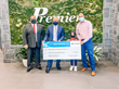 Robert J Alvine, President of Premier Subaru, Presents Shaun Heffernan of Camp Rising Sun a Check.  Lucy, a Camper at the Camp is the guest of honor