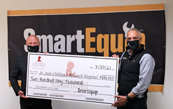 Regional Executive Director Timothy Bayly of ALSAC, the fundraising and awareness organization for St. Jude Children's Research Hospital accepts SmartEquip’s $250,000 donation from CEO Fern Piñera.