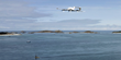 A Skyports delivery drone is shown in flight over the ocean.