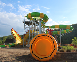 Large green and yellow waterslide with tube in front
