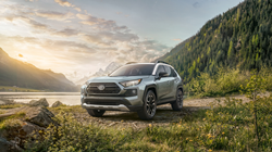 Front quarter view of the 2021 Toyota RAV4 parked by the lake