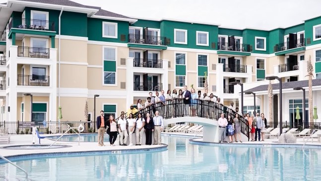 Crossing the bridge from "Under Construction" to "Now Open", Trevor Stratton, GM (center) and the staff of the Courtyard/Residence Inn Jekyll Island.