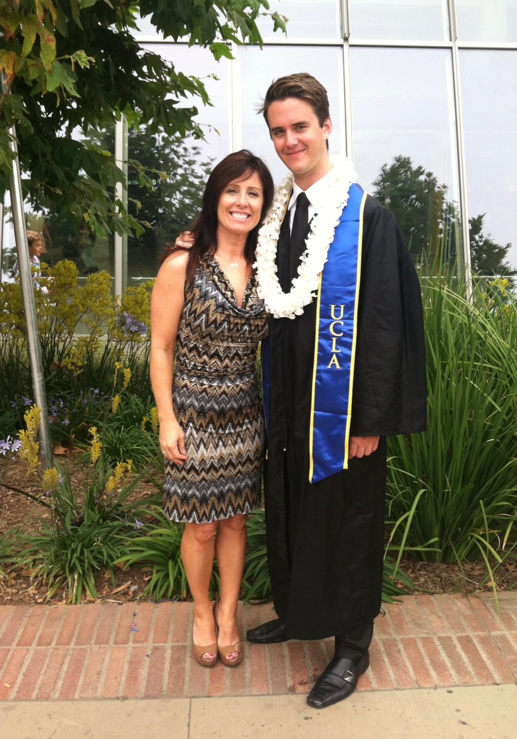 "Playing for Keeps" Author Therese Allison with her son at his UCLA Graduation, who she mentored to be a sports and business champion