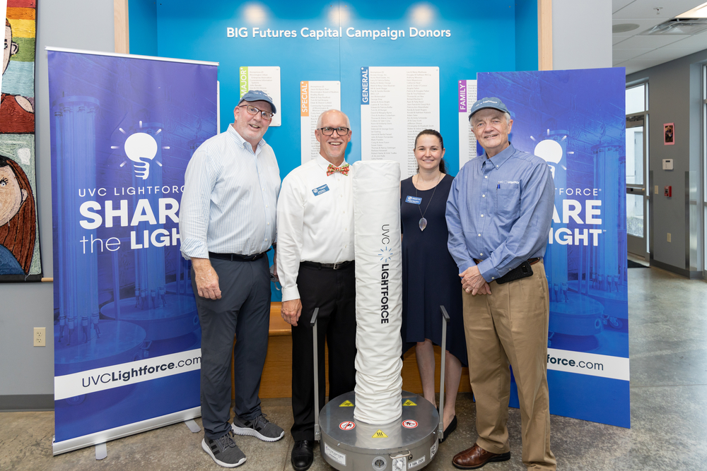 UVC Lightforce owners Rick Rechter II (far left) and Jerry Neely (far right) donate the first unit as part of the new Share The Light℠ campaign to Jeff Baldwin (Executive Director) and Courtney Payne-