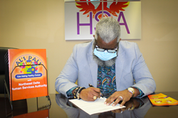 Northeast Delta Human Services Authority Executive Director Dr. Monteic A. Sizer signs the Al’s Pals agreement with Monroe City Schools.