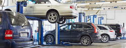 a car being lifted into the air by other cars
