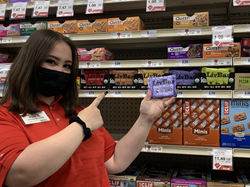 Hy-Vee employee holding a Blueberry Vanilla Kale LivBar