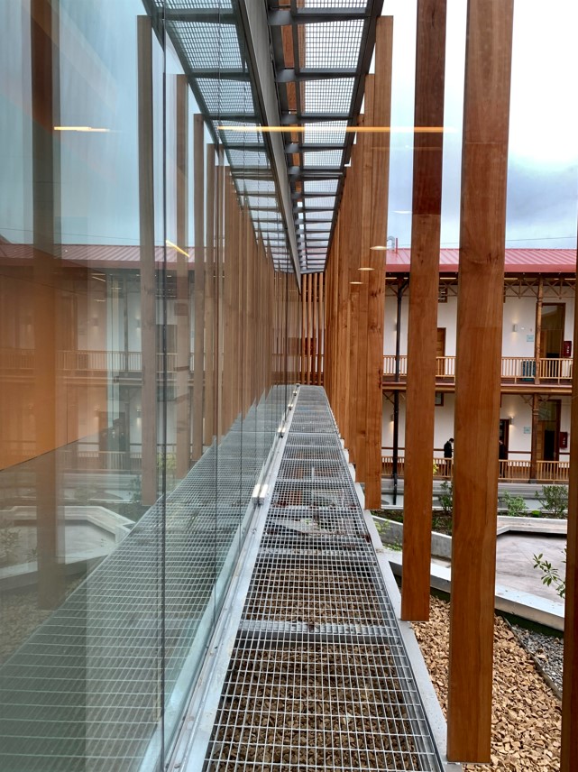 The team took great care to preserve distinctive features of the building, such as the open-air corridors that overlook the courtyard. Photo courtesy of luis vidal + architects.