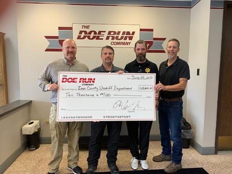 The Doe Run Company’s Anthony Staley (far left) and Brian Mangogna (far right) present a $10,000 donation to Troy Myers and Sheriff Jeff Burkett at the Iron County Sheriff’s Department. The donation w