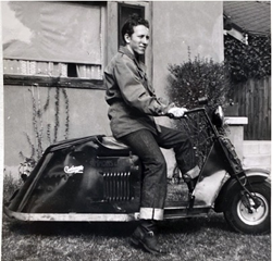 Old photo of a man on a motorbike