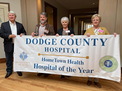 hospital leaders with banner