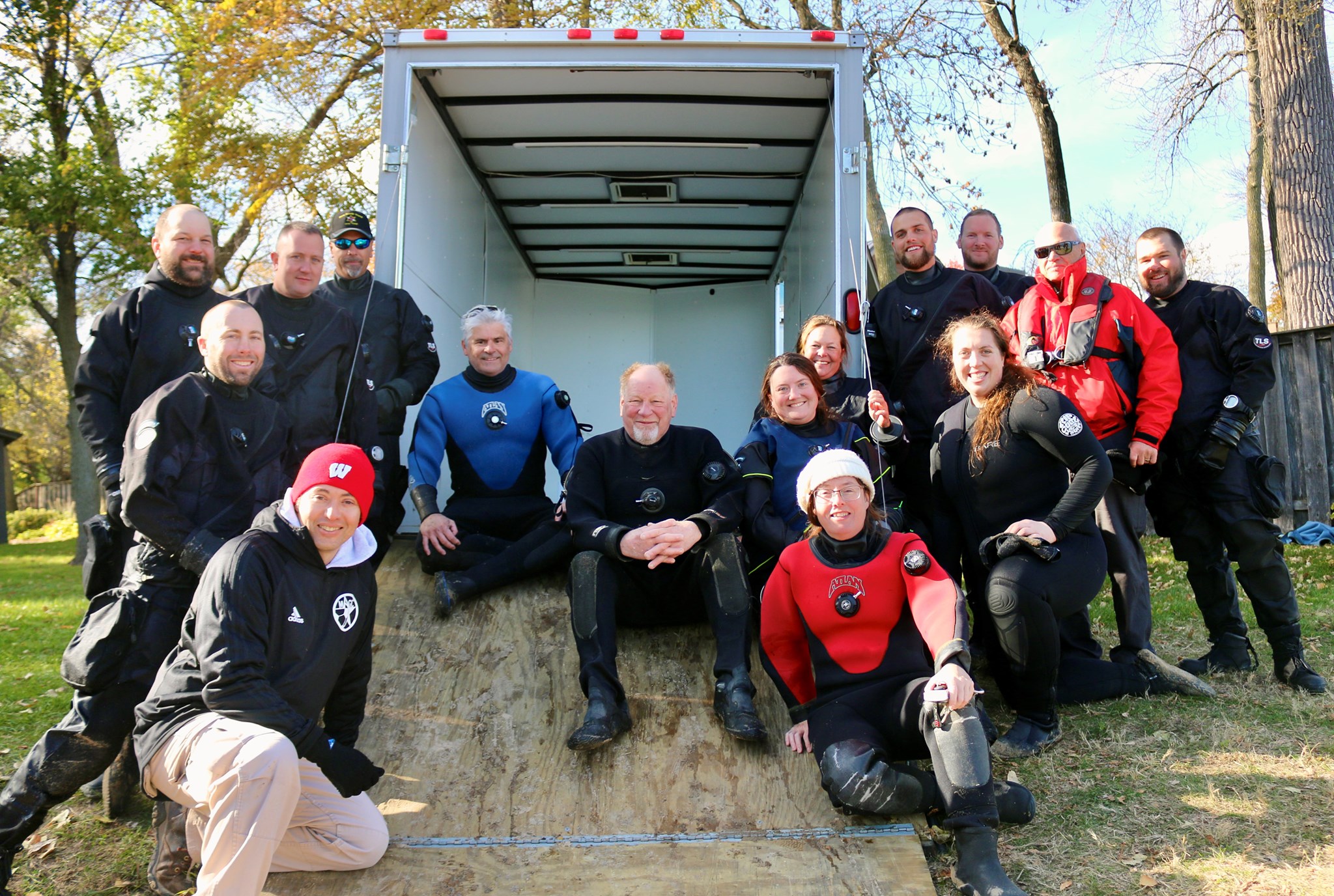 After a long day, archaeologists and divers paused for a photo with the circa A.D. 800 dugout canoe after a successful recovery from Lake Mendota.
