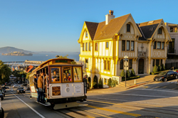 Cable car on Hyde Street with Alcatraz in the background.