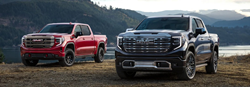 Two 2022 GMC Sierra 1500 pickup trucks next to each other