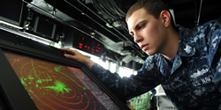 U.S. Navy Petty Officer 2nd Class Michael R. Gutermuth reads the SPS 73 radar on the bridge of the amphibious transport dock ship USS San Antonio (LPD 17). DoD photo by Petty Officer 3rd Class Zachary S. Welch, U.S. Navy.