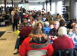 IMAGE: people eating Thanksgiving dinner at Watertown Ford Chrysler during its free annual Thanksgiving sitdown dinner - for Press Release: “Watertown Ford Chrysler to Host 20th Annual Complimentary Thanksgiving Dinner, Deliveries Available” by Francis Mariela Communications