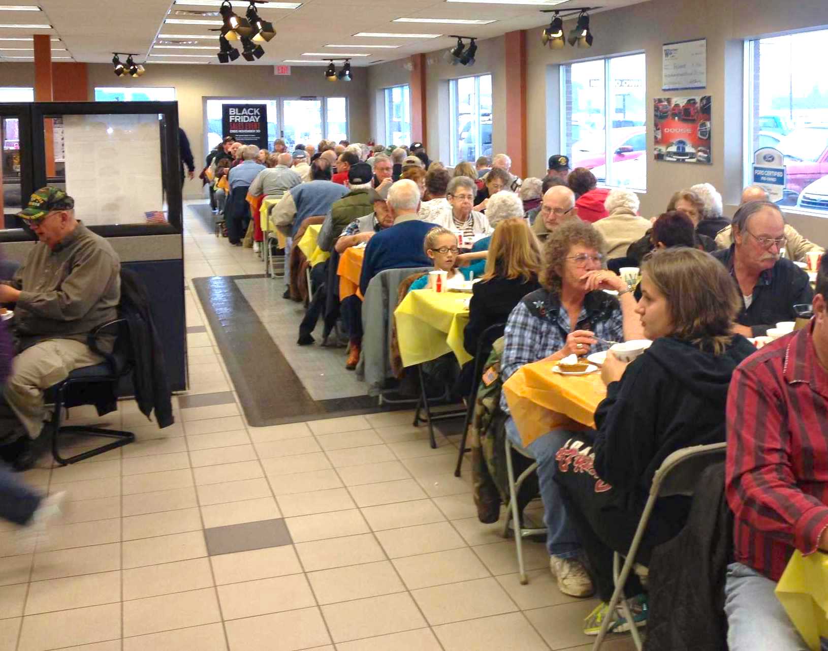 Community members enjoy Thanksgiving dinner at Watertown Ford Chrysler during the dealer’s annual complimentary Thanksgiving sit down dinner
