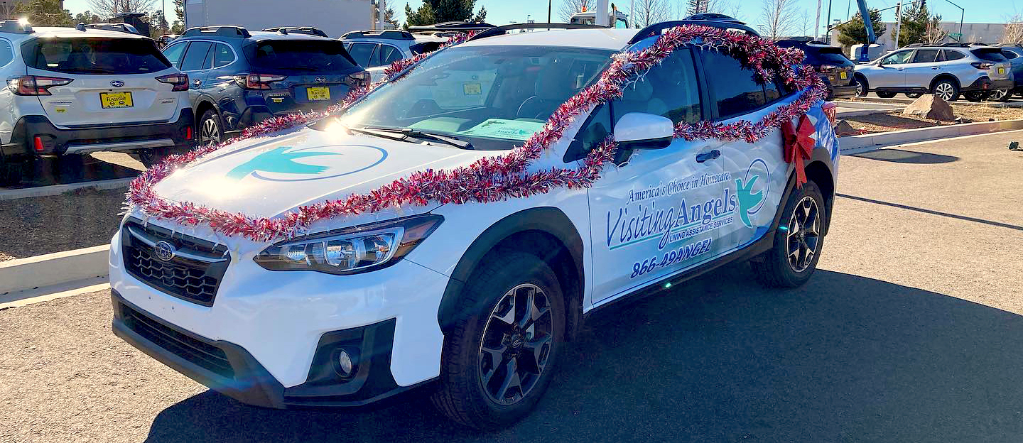 Visiting Angels Home Care’s decked out Subaru at last year’s Candy Cane Lane event at Flagstaff Subaru